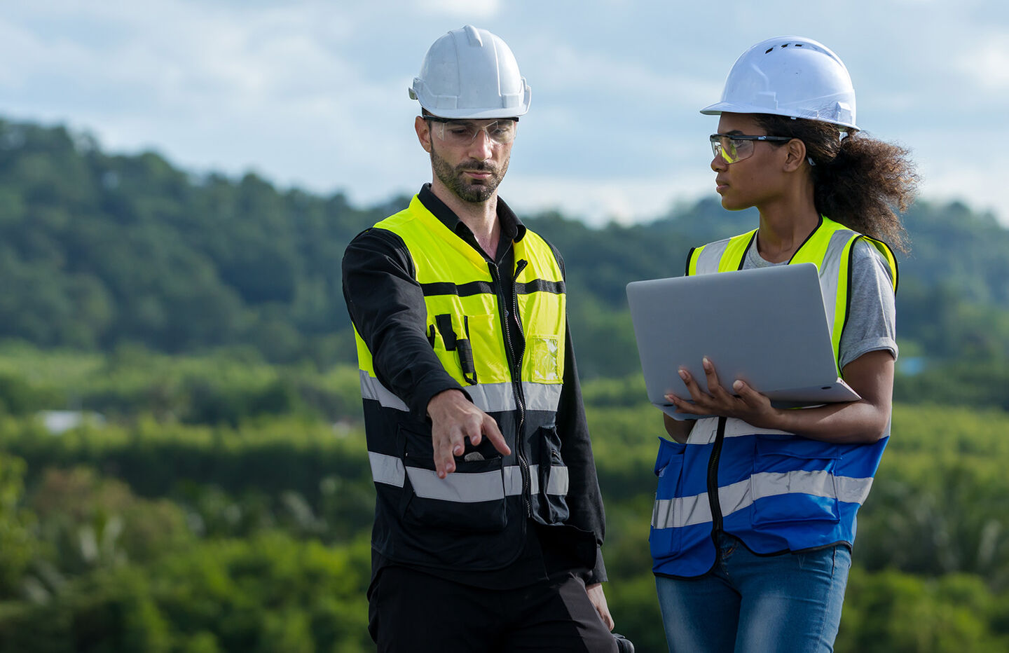 A male and female engineer review a project plan