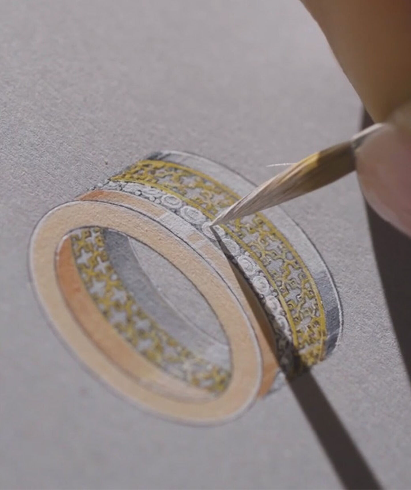 an artist paints a picture of a ring