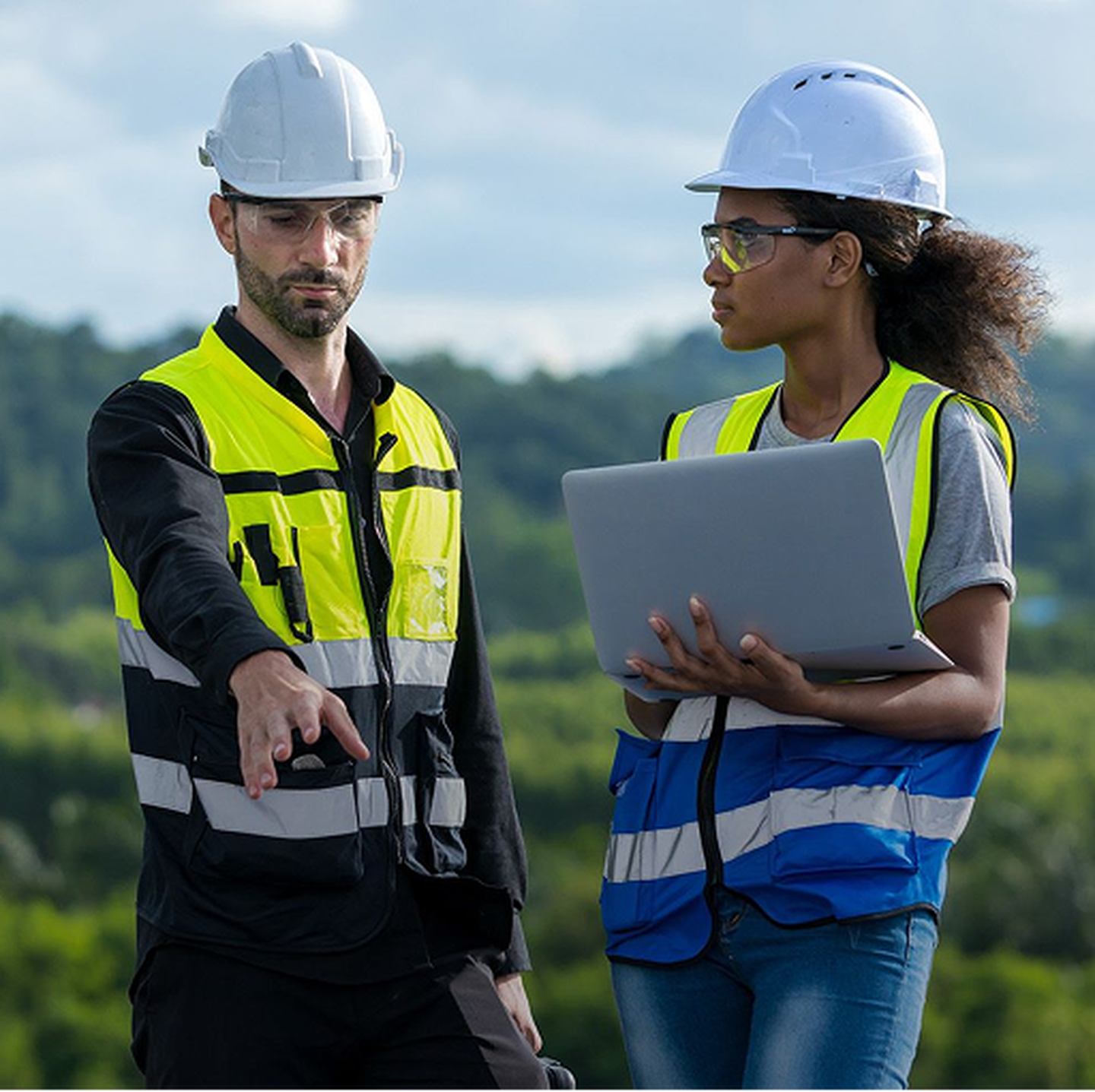 A male and female engineer review a project
